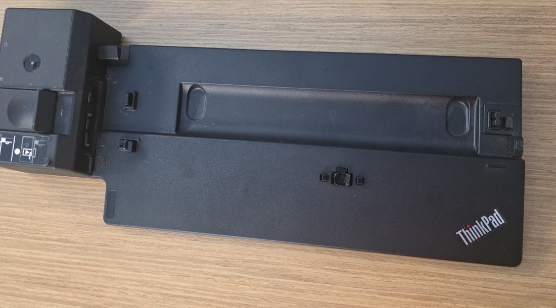 ThinkPad mechanical bottom-dock showing the spring-loaded gold contact block and alignment posts