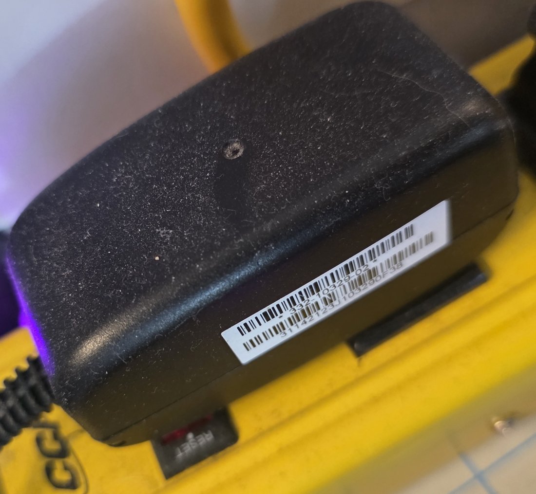 Switching wall wart adapter plugged into a yellow power strip